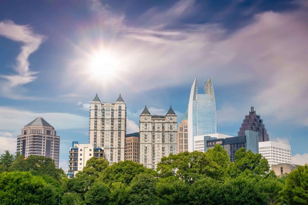 Different types of trees in Georgia underneath the city skyline.